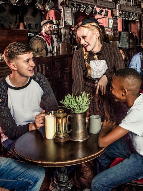 Visitor enjoying drinks with performers at London Dungeon.