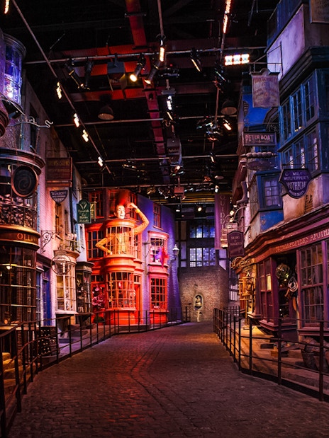 Diagon Alley scene on Harry Potter London tour with cobblestone street and magical shopfronts.