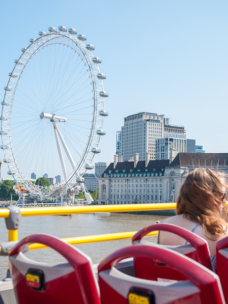 Tootbus on London street near Big Ben, offering Hop-On-Hop-Off Bus Tour with Thames River Cruise.
