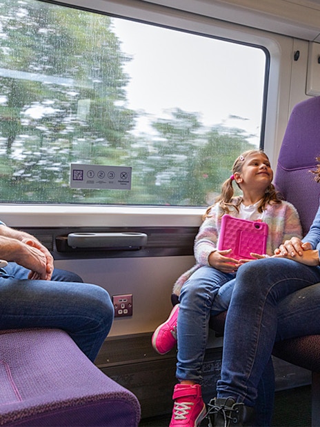 Family enjoying their train transfer from Heathrow Airport to London Paddington via Heathrow Express