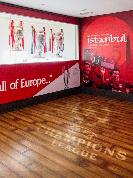 Visitors exploring the iconic Liverpool FC Stadium during a guided tour, with Museum Entrance Tickets included