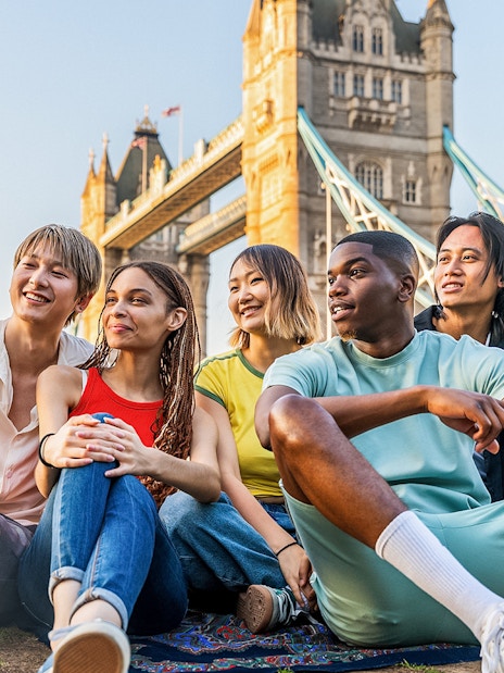 Tourists on Tower Bridge viewing London's skyline, showcasing exclusive access with Tower Bridge tickets.
