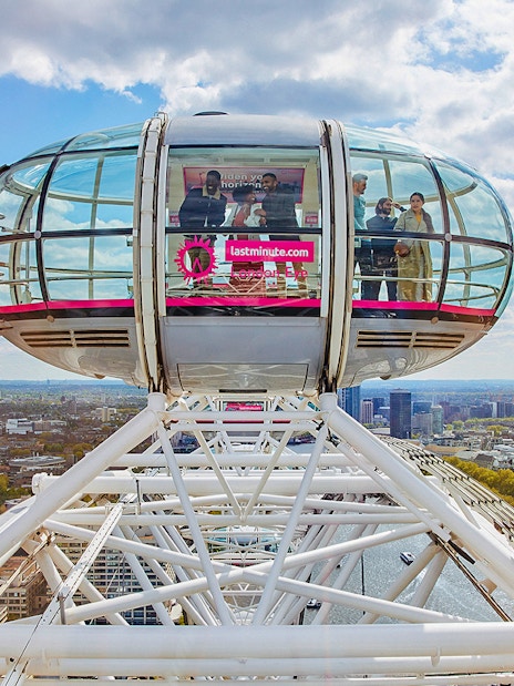 London Eye and Thames River Cruise view with Kew Gardens in the background, London.