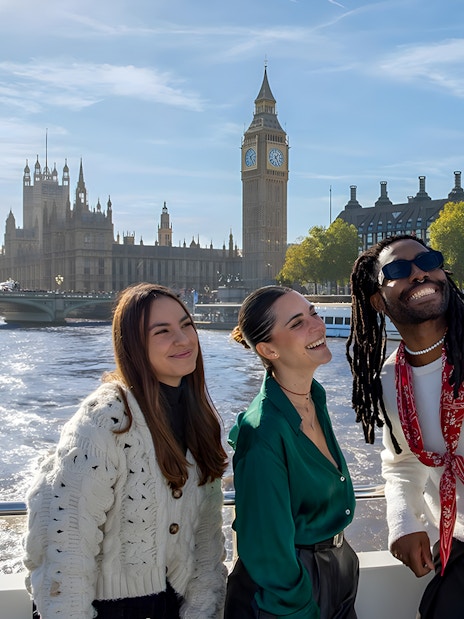 Thames River cruise boat passing by the London Eye and Big Ben, London Sightseeing Cruise.