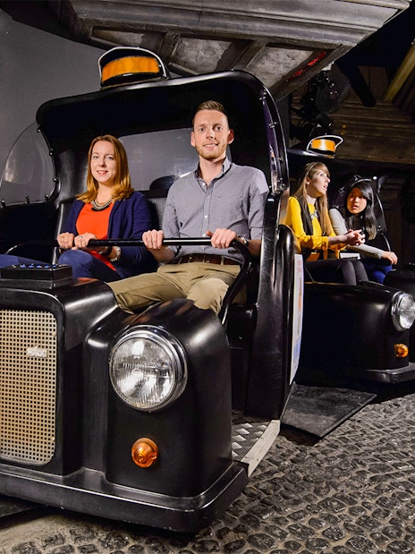 Double-decker bus on Spirit of London Ride near Big Ben and Houses of Parliament.