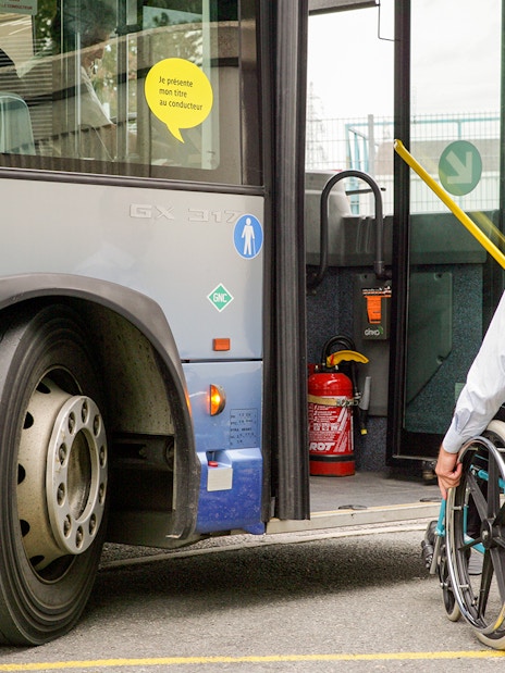 Man in wheelchair boarding bus at Oxford for transfer to London Heathrow Airport