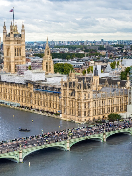 View of Big Ben under construction, Houses of Parliament, and Westminster Bridge from the London Eye, London, UK.
