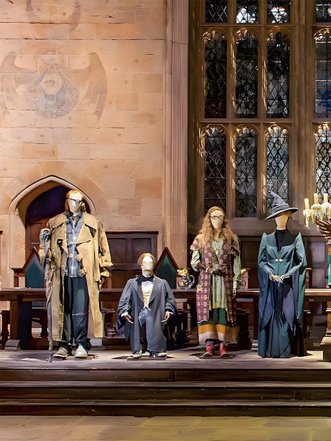 Costume exhibit at Harry Potter London tour showcasing iconic wizard robes.