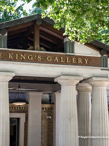 Entrance to The Kings Gallery at Buckingham Palace with ornate columns and grand archway.
