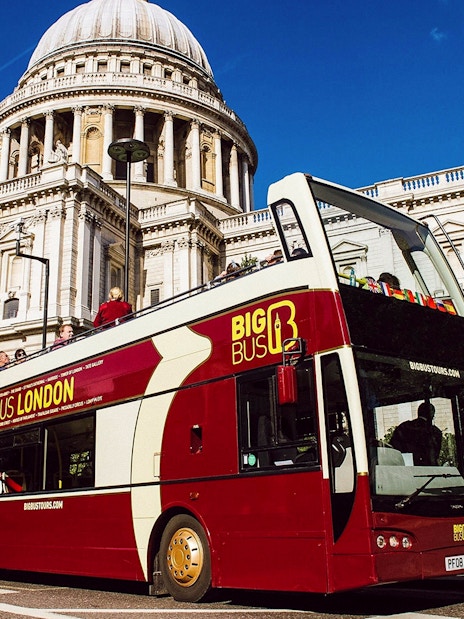 Double-decker bus on London Big Bus Hop on Hop off Tours passing by the iconic Big Ben.