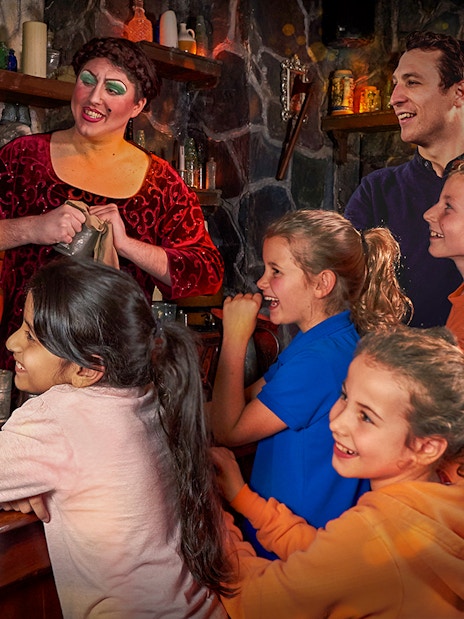 Visitors enjoying the interactive Shrek's Adventure! London Tickets tour, featuring beloved characters from the Shrek franchise in a vibrant, immersive setting.