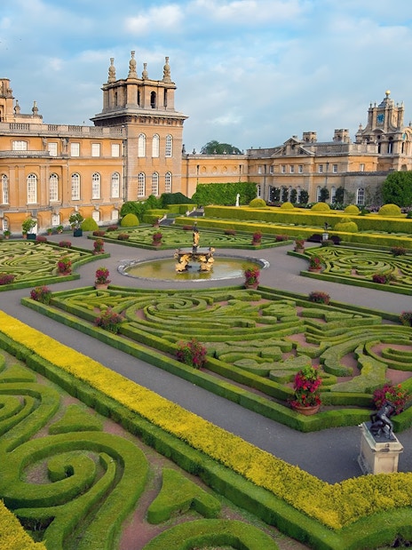 Blenheim Palace gardens with tourists exploring, part of Downton Abbey Village & The Cotswolds Tour.