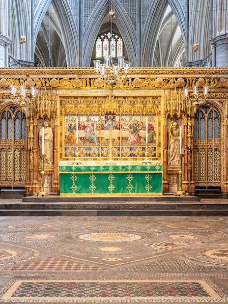 High Altar inside Westminster Abbey with intricate Gothic architecture and stained glass windows.