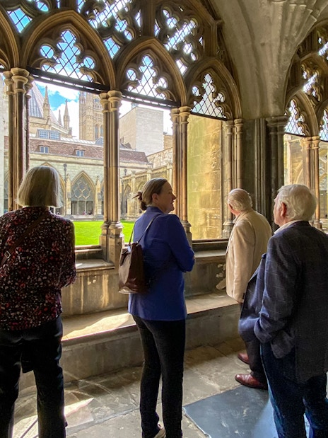Tourist listening to guide inside Westminster Abbey, London.