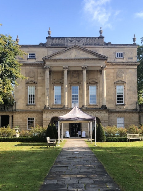 Bath city street with Georgian architecture, Bridgerton tour group, live music performance.