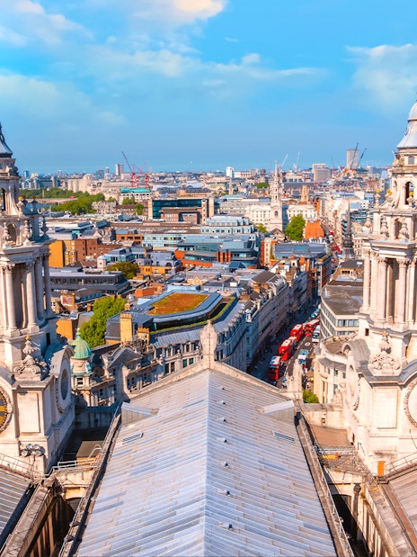 Aerial view from St Paul's Cathedral's Golden Gallery, showcasing twin baroque towers and London's skyline.