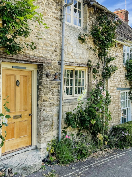 A female tourist walking on the streets of Burford