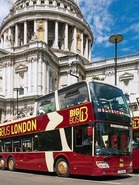Big Bus London tour passing by the iconic Tower Bridge in London.