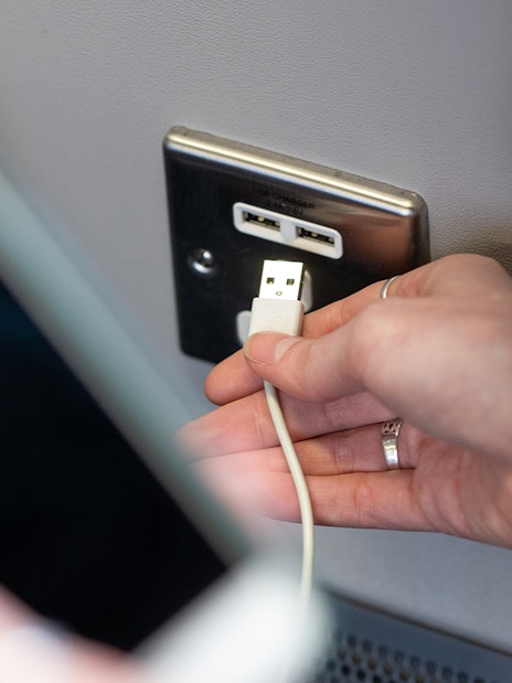 Heathrow Express train interior with charging socket and seating.