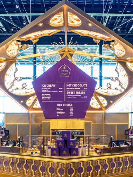 Frog cafe interior on Harry Potter London tour with themed decor and visitors.