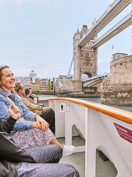 Tourist on river cruise viewing Tower Bridge in London.