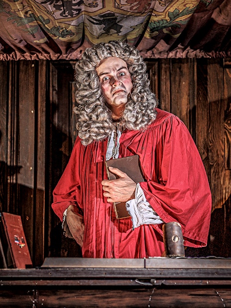 Actors reenacting a historical trial scene in The Courtroom at London Dungeon.