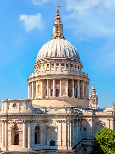 St. Paul's Cathedral dome with London skyline from visitor viewpoint on sunny day.