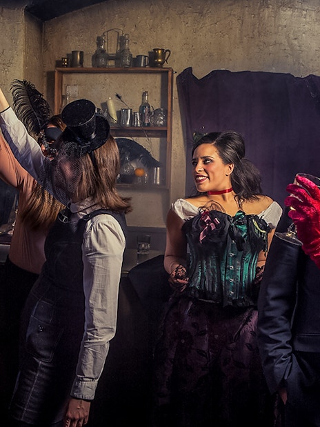 Visitor enjoying drinks at London Dungeon bar.