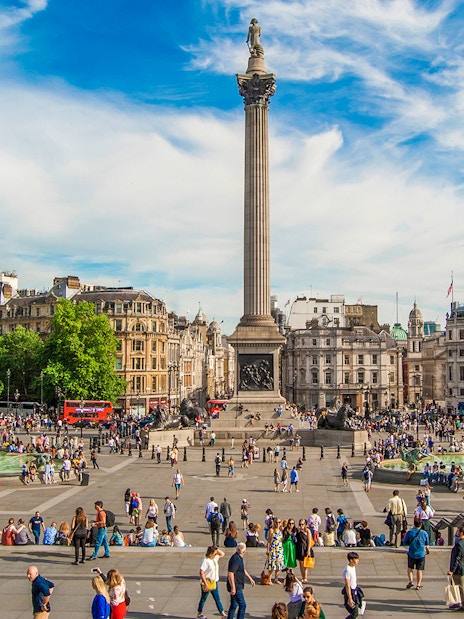 Tourists at Trafalgar Square on Westminster walking tour, London.
