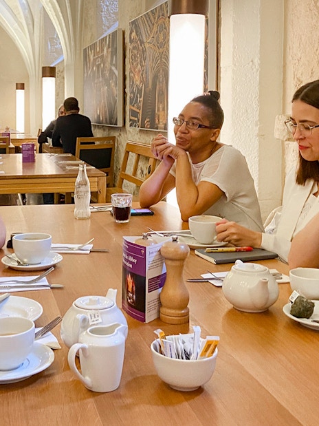 Tourists enjoying coffee and pastries in the 14th century Cellarium