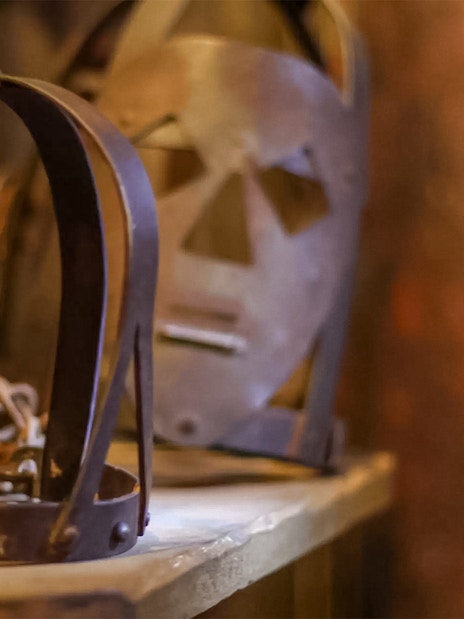 Visitors exploring The Clink Prison Museum in London, viewing historical prison artifacts.