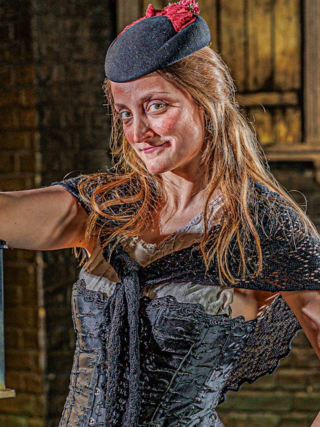 Visitors exploring the eerie corridors of the London Dungeon with historical exhibits.