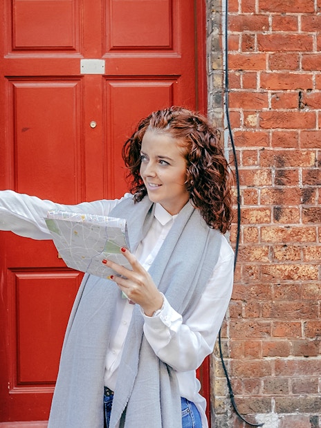 A female guide giving directions to tourist in Westminister