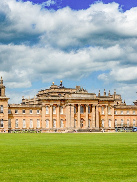 Blenheim Palace exterior with grand architecture and lush gardens in Oxfordshire, England.