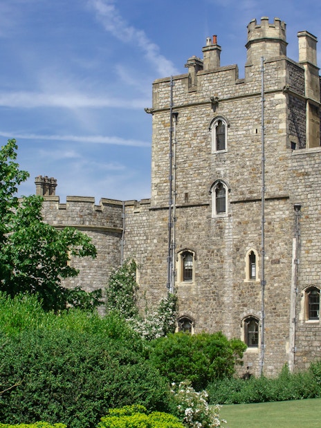 Windsor Castle exterior with tourists exploring the historic architecture in London, England.